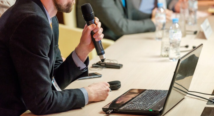 speaker holding wireless microphone